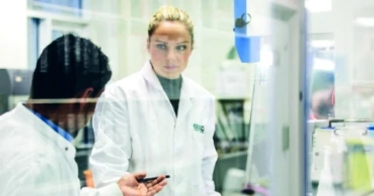 Biotech research lab with scientists conducting experiments