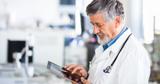 Doctor reviewing data on tablet