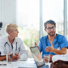Hepatologists discussing liver treatments