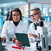 lab workers on tablet and computer