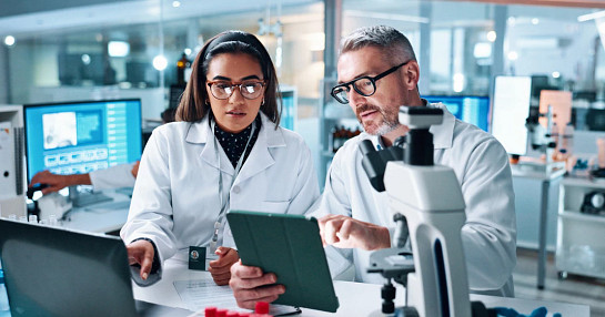 lab workers on tablet and computer