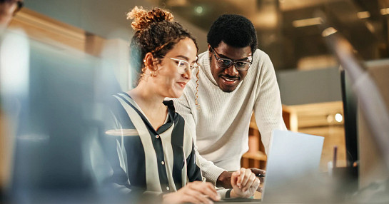 people in meeting with laptop