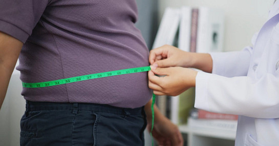 people measuring waist with meter