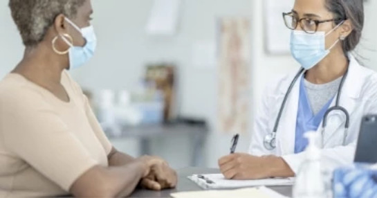 Physician consulting with study participant