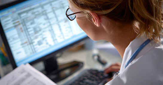 woman working on laptop with statistics