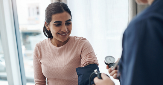 doctor measuring blood pressure on patient